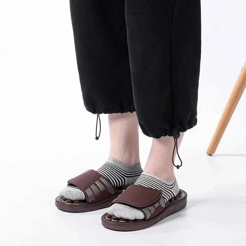Foot massager acupuncture slippers with adjustable straps for reflexology therapy.